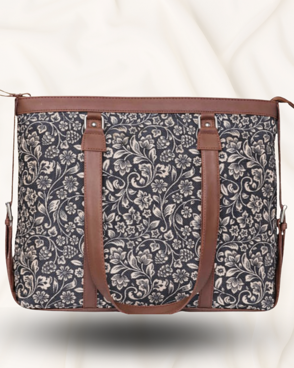 Floral patterned bag with brown straps on a white background