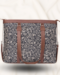 Floral patterned bag with brown straps on a white background