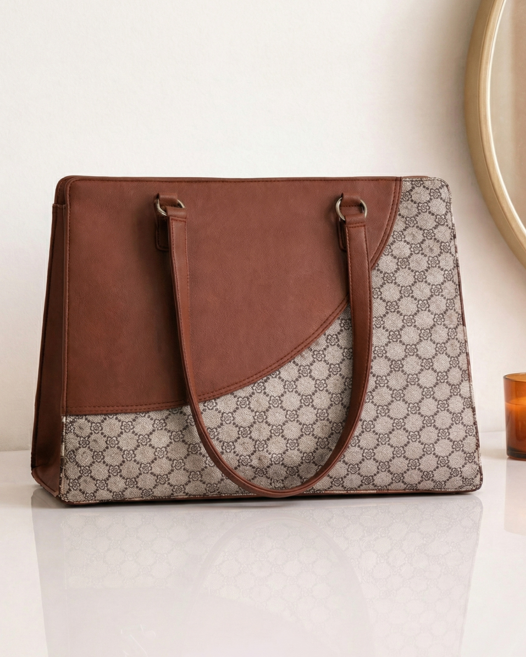 Brown and patterned tote bag on a white surface with a neutral background