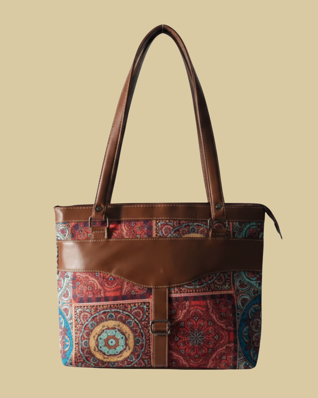 Brown tote bag with colorful patterned flap on a beige background
