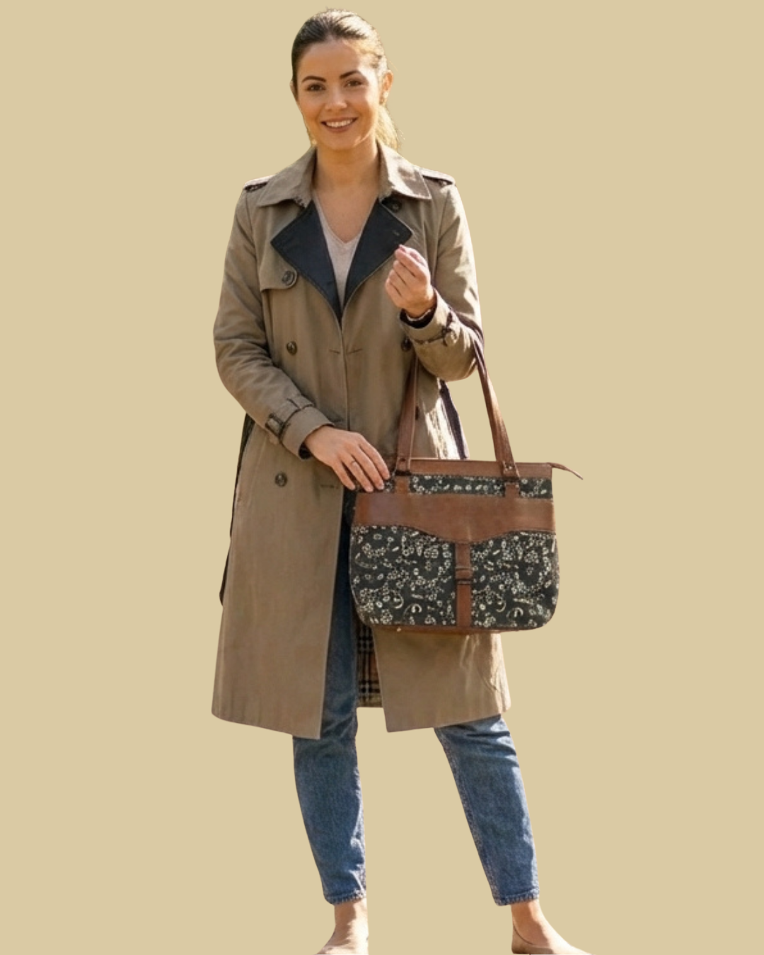 Woman holding a floral-patterned handbag against a beige background