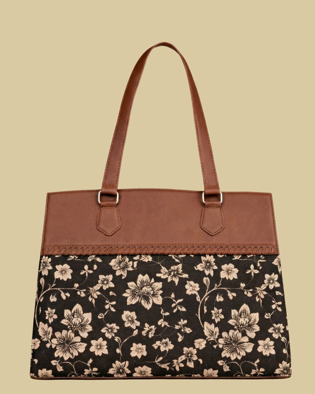 Floral-patterned handbag with brown leather top section on a beige background