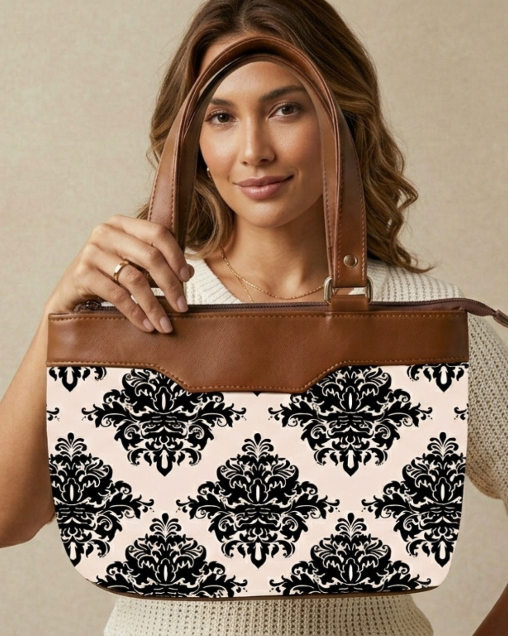 Woman holding a tote bag with black floral pattern on a beige background