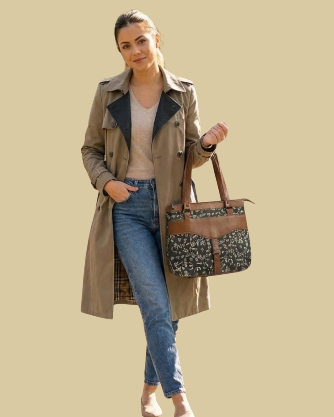 Woman holding a patterned handbag against a beige background