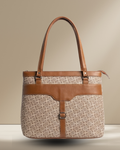 Handbag with patterned body and brown leather straps on a beige background