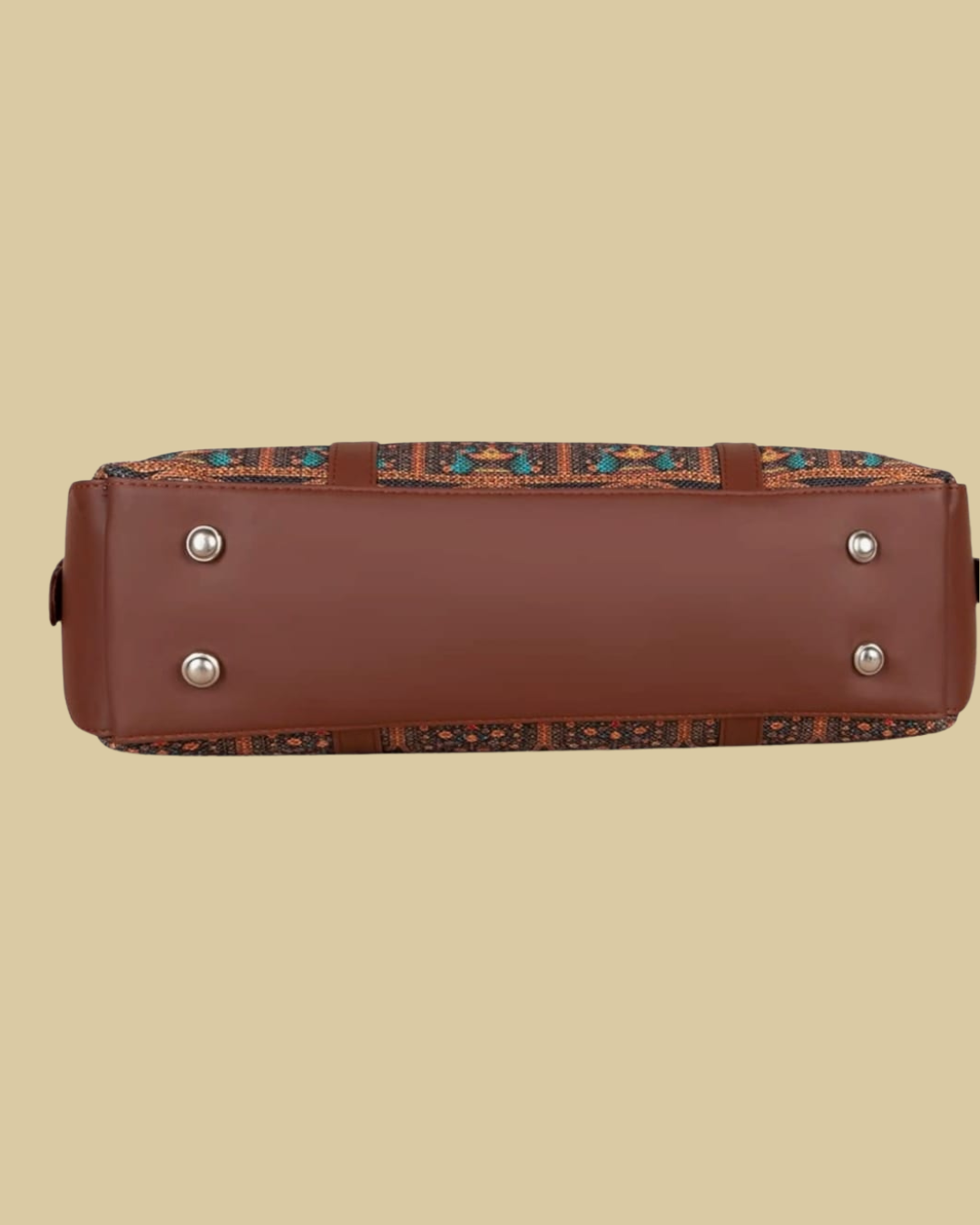 Brown leather bag with decorative patterned strap on a beige background