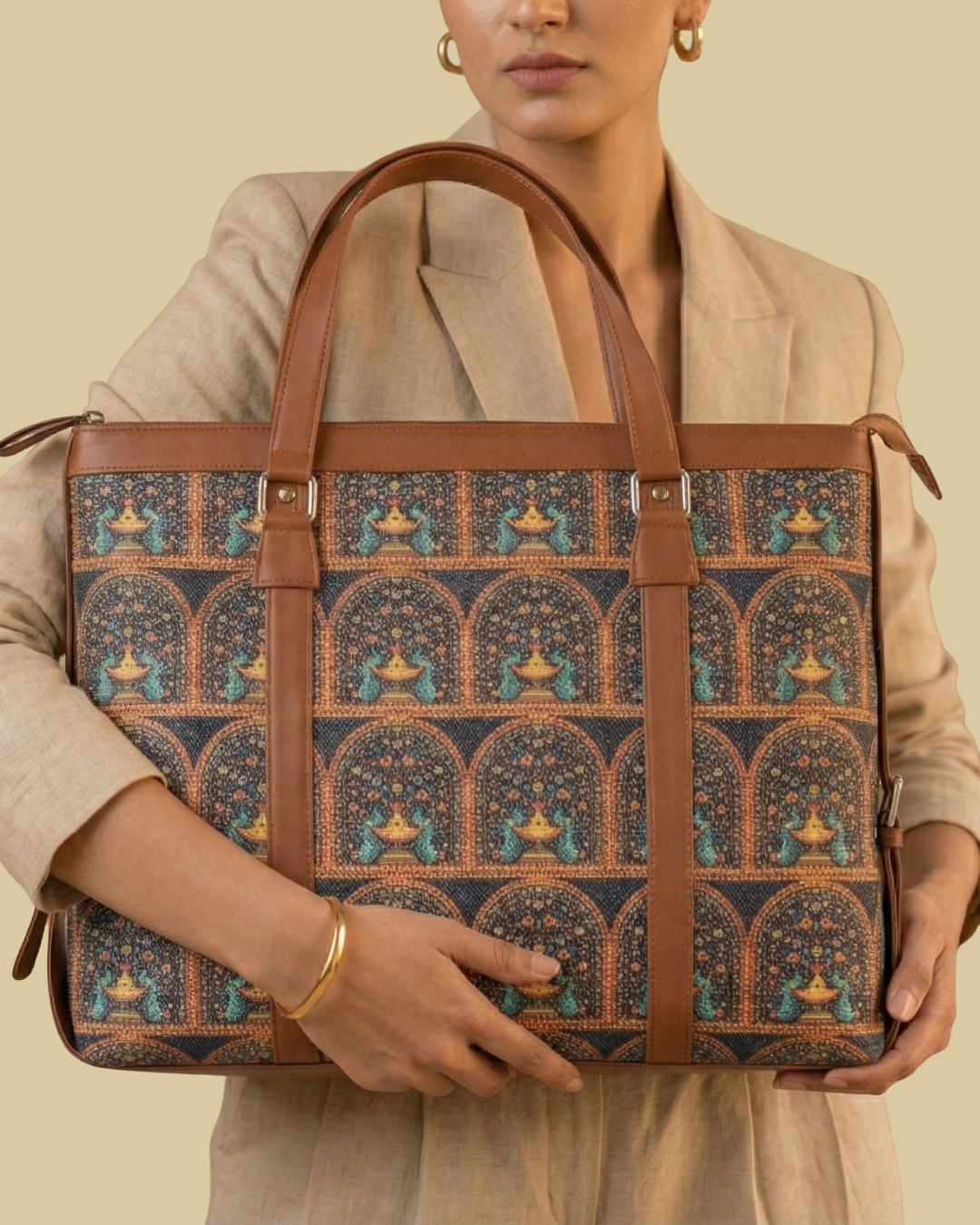 Person holding a patterned bag with brown handles against a beige background