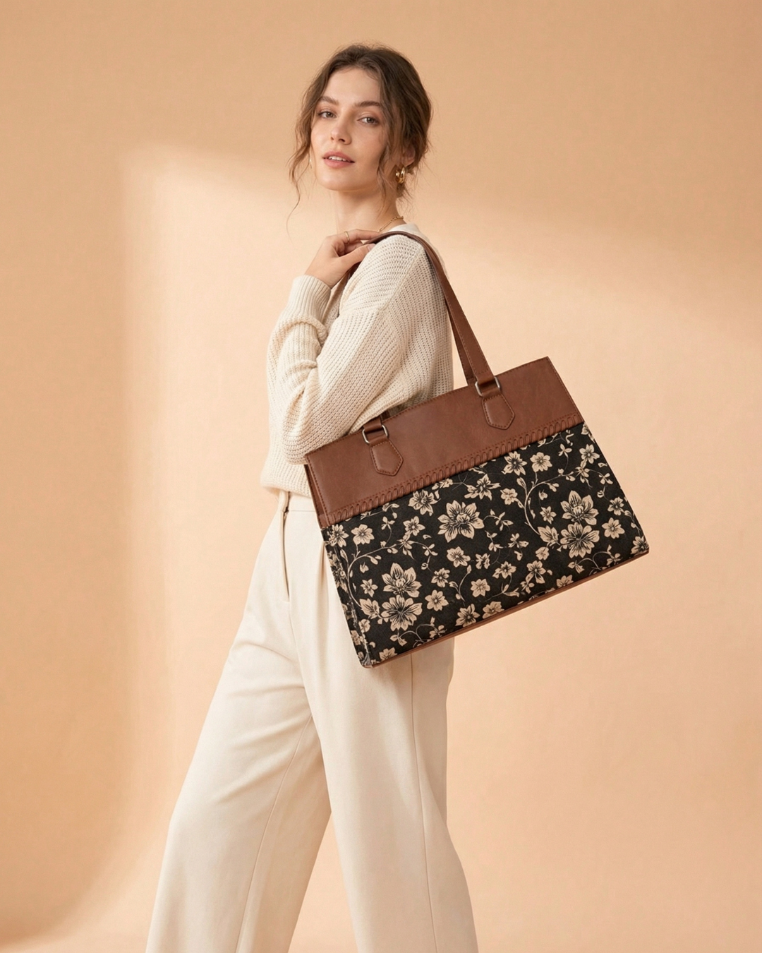 Woman holding a floral-patterned bag against a beige background