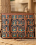 Patterned bag with brown handles on a wooden surface