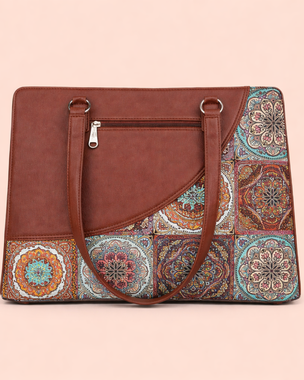 Brown handbag with a colorful patterned flap on a light pink background