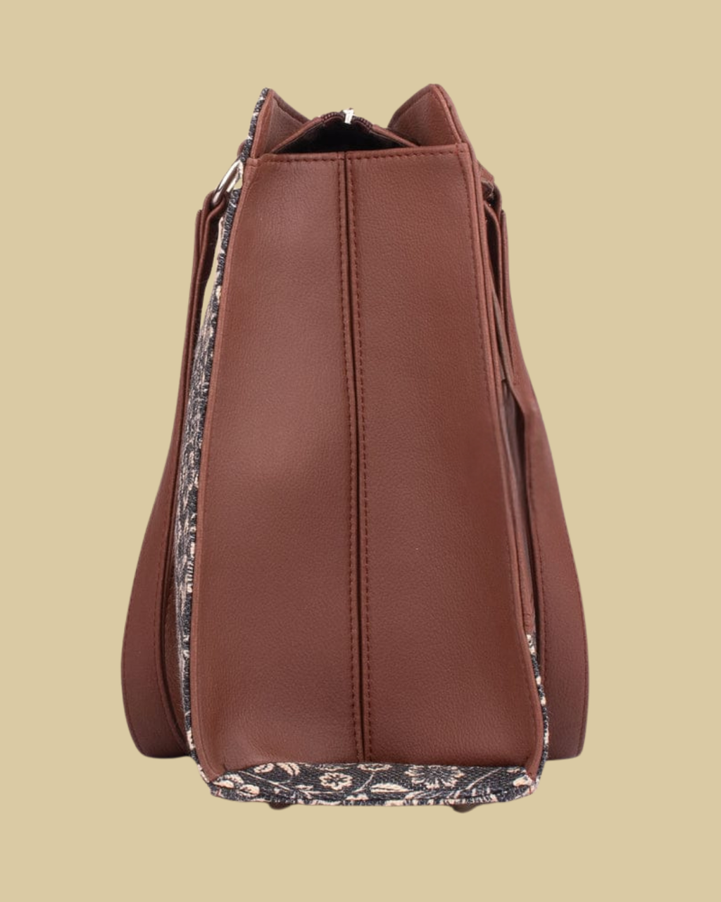 Brown leather bucket bag with floral lining on a beige background