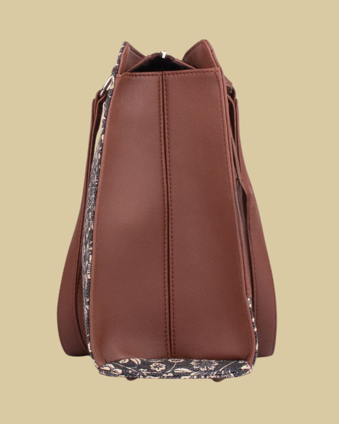 Brown leather bucket bag with floral lining on a beige background