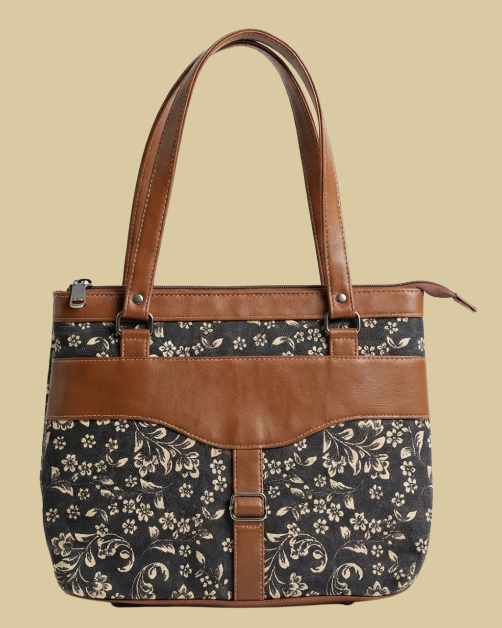 Floral-patterned handbag with brown leather accents on a beige background