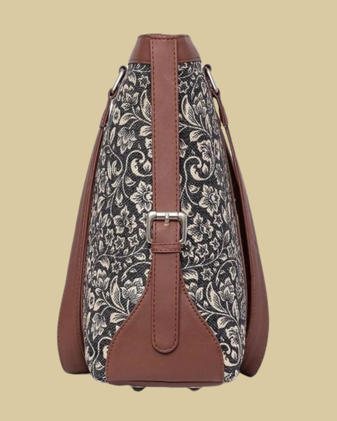 Floral-patterned bag with brown leather straps on a beige background