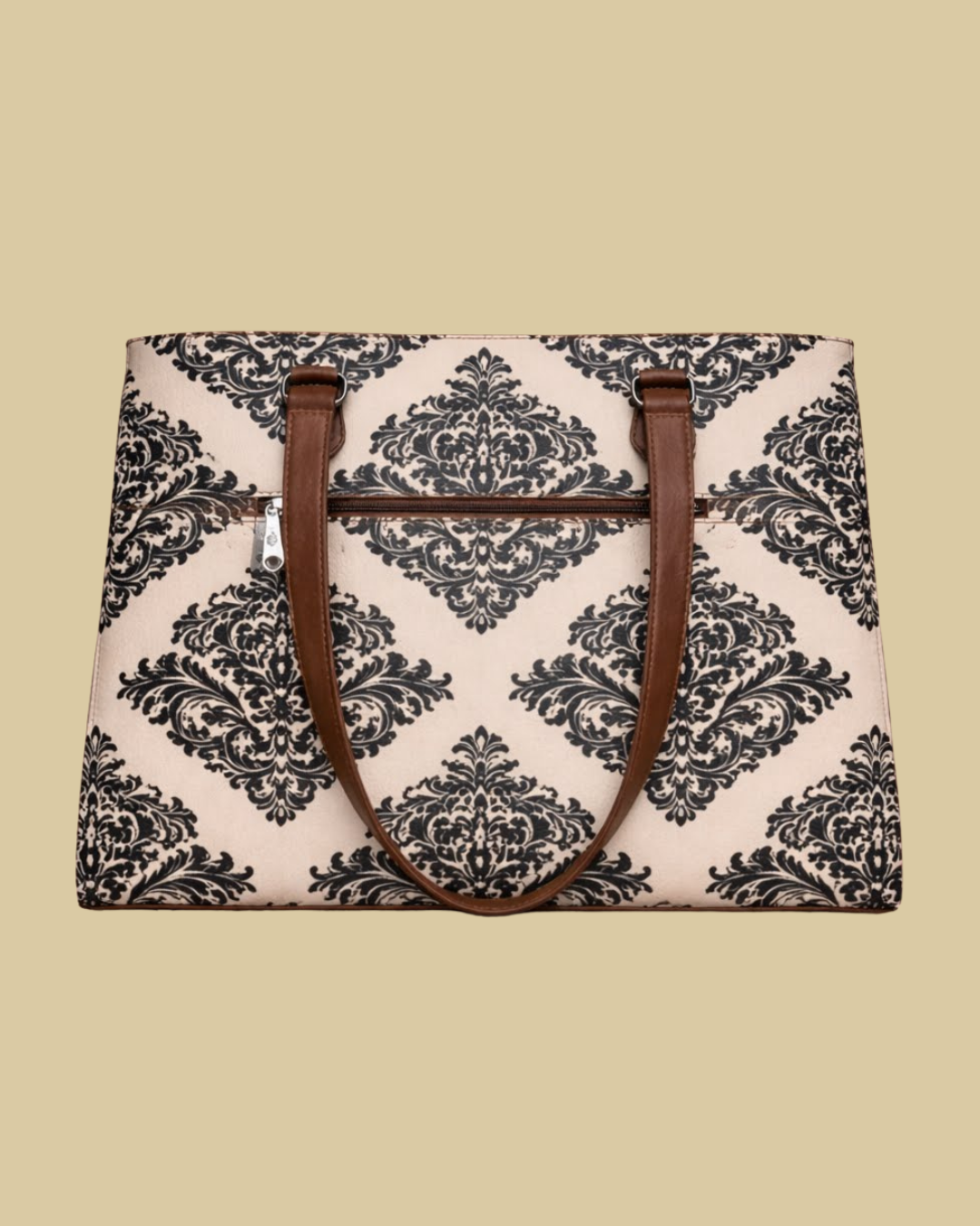 Bag with black floral pattern and brown handles on a beige background
