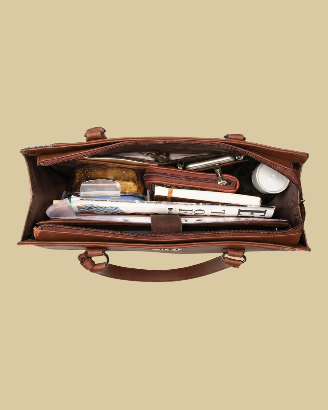 Open brown leather briefcase with office supplies on a beige background