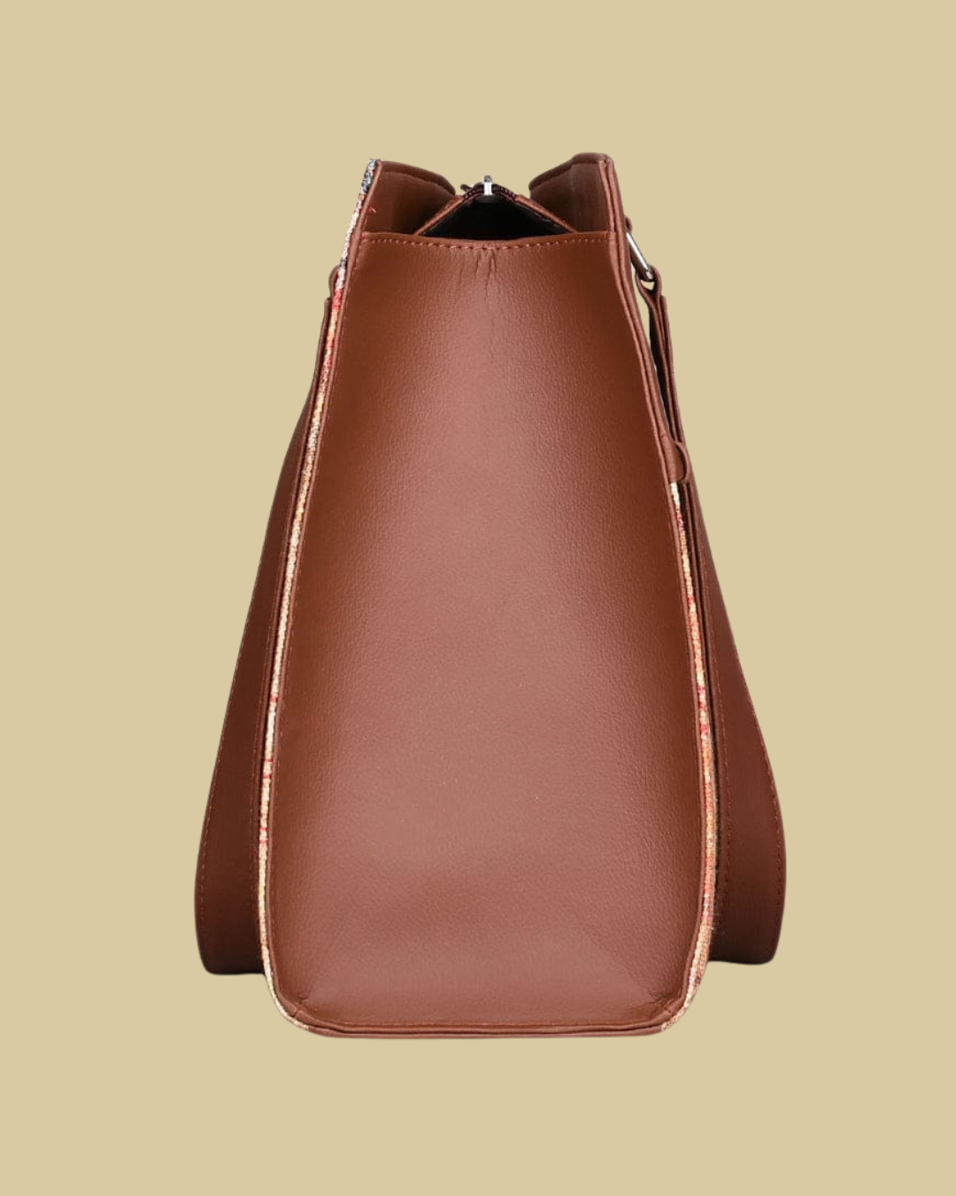 Brown leather handbag on a beige background