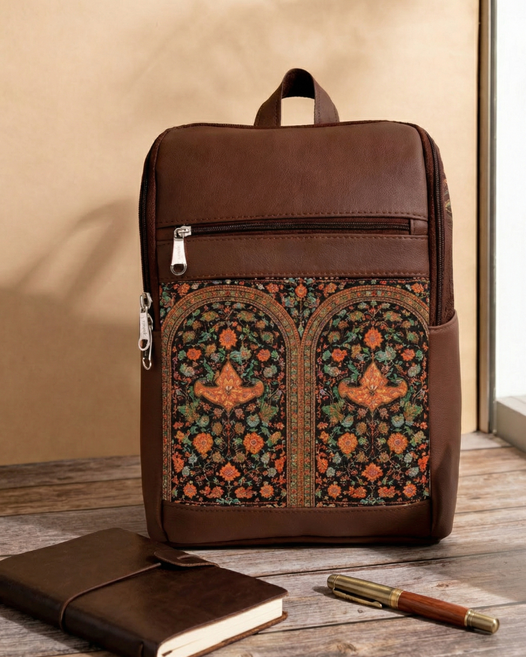 Brown backpack with floral pattern on a wooden surface