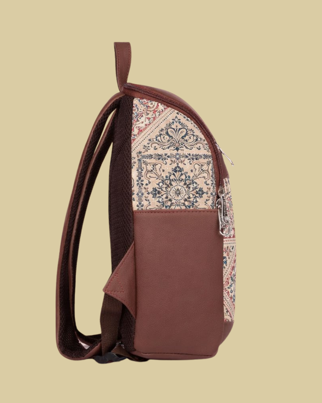 Brown backpack with patterned flap on a beige background