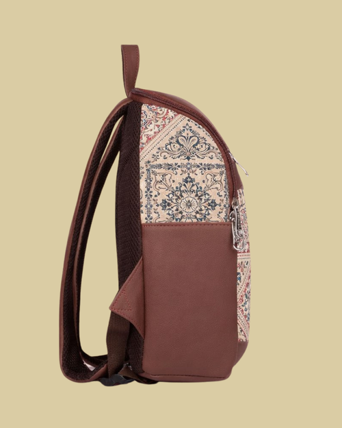Brown backpack with patterned flap on a beige background