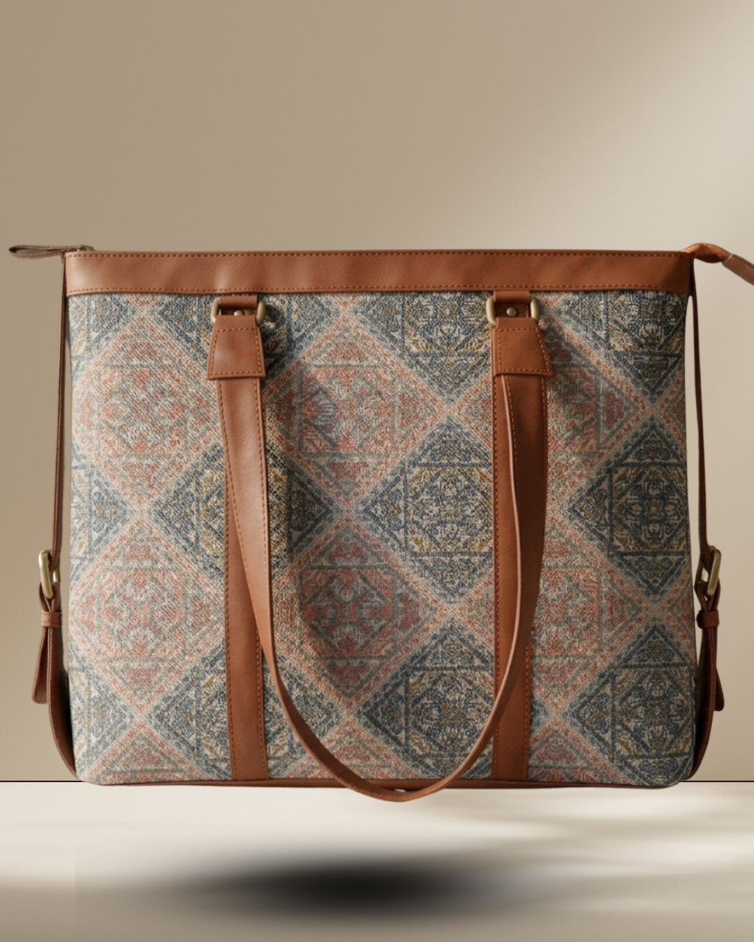 Patterned bag with brown leather straps on a neutral background
