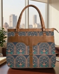 Patterned tote bag with brown leather accents on a desk with a cityscape in the background